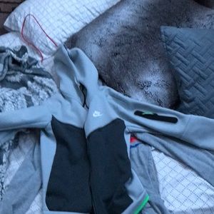 A Nike tech hoodie grew and black